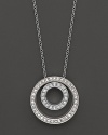 Circles of 14K white gold are a striking backdrop for glittering diamonds.