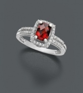 Cause a stir with this red hot number. A vivacious ring that features oval-cut garnet (1-1/10 ct. t.w.) with round-cut diamond (1/6 ct. t.w.) around the edges and in double rows at the band. Ring crafted in 14k white gold.