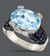 The perfect splash of color. Le Vian's cool blue ring features an oval-cut blue topaz (6-5/8 ct. t.w.), surrounded by round-cut diamonds (1/10 ct. t.w.) and sapphires at the shoulders (1-1/4 ct. t.w.). Crafted in 14k white gold.