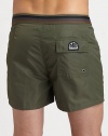 Comfortable swim trunks, in quick-drying nylon, are highlighted by a striped detail along the waistband and back flap pocket with grip-tape closure.Snap button-frontRear flap pocketInseam, about 3NylonMachine washImported