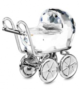 A fantastic gift for the new parents! In multifaceted cut-crystal, Swarovski has designed a fanciful little baby carriage. Decorative metal accents surround the figurine and the wheels actually turn.