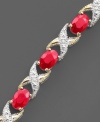 Oval-cut rubies (8 ct. t.w.) are brilliantly complemented by glittering round-cut diamonds (1/10 ct. t.w.) and set in 14k gold. Bracelet measures 7 inches.