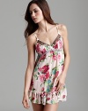 Girlish charm emanates from this rose printed babydoll with delicate lace and ruffle trim.