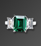 Finish your look with precision style and vibrant color. CRISLU's eye-catching ring highlights an emerald-cut green cubic zirconia center (6 ct. t.w.) with a clear cubic zirconia (2-1/2 ct. t.w.) on either side. Ring crafted in platinum over sterling silver. Sizes 5, 6, 7, 8, and 9.