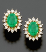 Shining stud earrings bursting with brilliance. Oval-cut emerald (1/2 ct. t.w.) and round-cut diamond (1/2 ct. t.w.) are set in 14k gold. Approximate length: 1/2 inch.