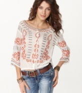 Embrace boho-chic with this embroidered peasant top from Free People. Pair it with jeans and boots for an on-trend look.