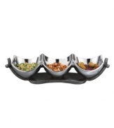 Set or simply decorate the table with the ultra-modern Anvil condiment bowl from Nambe's collection of serveware and serving dishes. A sculptural, iron-finished base cradles contoured silvertone alloy in this innovative Neil Cohen design.