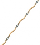 Cool blue. Victoria Townsend's stunning bracelet combines oval-cut blue topaz (1-5/8 ct. t.w.) and diamond accents in 18k gold over sterling silver. Approximate length: 7-1/4 inches.