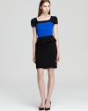 Jay Godfrey's peplum dress exudes modernity in a cool color block design, finished with an exposed zipper for subtle edge.