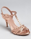 Glamour meets edge on these gilded VINCE CAMUTO sandals, covered in golden studs and a metallic finish.