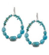 A striking silhouette. Turquoise nuggets and chips add dimension to this stunning pair of drop hoops by Avalonia Road. Set in sterling silver on fish wire. Approximate drop: 2 inches.