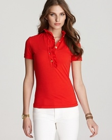 An update to the traditional polo shirt -- pristine gold-tone buttons and delicate ruffles lend a feminine finish to the classic style. Pair with jeans and Tory Burch flats for a crisp, American-girl look.