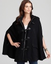 The season's must-have item, this Joie cape boasts a hood and funnel collar for chic, plus timeless toggle closures through the front. Arm slits lend functionality to the trend-right style, featuring leather trim throughout.