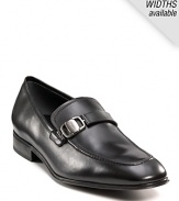 Sleek and stylish slip-on dress shoes with leather strap and buckle detail at top. Round toe. Gancini insignia etched on buckle and heel. Leather sole with slightly stacked heel.