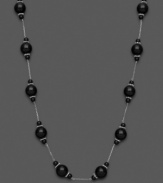 Mysterious loveliness. Show your dark side with this necklace with black onyx beads (4-10 mm). Set in sterling silver. Approximate length: 18 inches.