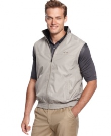 Look great on or off the golf course with this water resistant wind vest by Greg Norman for Tasso Elba.