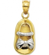 Commemorate your brand new bouncing baby girl. This precious charm features a baby shoe in 14k gold with rhodium ribbon and strap details. Chain not included. Approximate length: 1 inch. Approximate width: 2/5 inch.