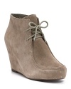 Desert styling meets the wedge in these lace-ups, characterized by clean lines and a soft suede finish. By DV Dolce Vita.