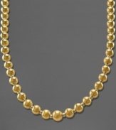 This traditional graduated necklace shines bright with beautiful beads of 14k gold over sterling silver and sterling silver. Approximate length: 18 inches.