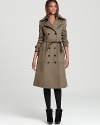 A Burberry London wool and cashmere trench coat touts a lush shearling collar for sumptuous style through the cold weather season.