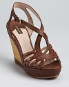 A modern masterpiece from Joan & David--the Dreena sandals boast knotted details and a raffia-wrapped wedge.