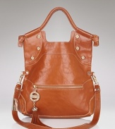 Bright stud detailing in gleaming gold tone and a bold tassel bring star style to Foley + Corinna's sleek leather tote.