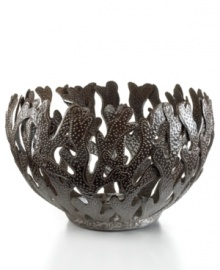 Made entirely of recycled steel, the Coral bowl is intricately cut and hammered by Haitian metal artisans to evoke the life-giving sea that laps their shores. Rich texture in its crisscrossed branches add to the special nature of each handmade piece.