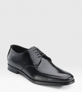 Highly polished Italian spazzolato leather lace-up oxford with an apron toe. Leather lining Padded insole Leather and rubber sole Made in Italy 