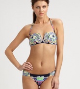 A bold, eclectic print and classic bikini silhouette combine to create an alluring design, including a removable halter strap for style versatility. Removable halter strapBandeau topBack clasp closureSexy, ruched sides on stretch bottomFully lined80% nylon/20% spandexHand washMade in USA