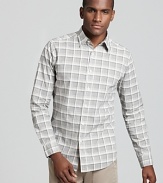 A large plaid print in light gray stylishly elevates a slim fit button down from Theory.