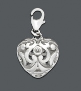 Add a drop of silver sophistication to any necklace or bracelet. This intricate scrolling heart charm features cubic zirconia accents. Set in sterling silver. Approximate drop: 1/2 inch.