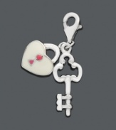 The key to happiness is through the heart. These delicate charms will add the finishing touch to any necklace or bracelet. Crafted in sterling silver with cubic zirconia accents, charm features a key with a pink and white heart-shaped lock. Lobster claw clasp. Approximate drop: 1-1/5 inches.