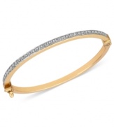 A beautiful statement. This bangle bracelet is crafted from 14k gold with diamond accents adding to the sparkle. Approximate diameter: 1-5/8 inches x 1-3/8 inches.