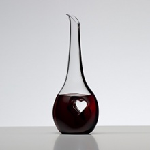 For over 250 years, Riedel Crystal's collections have become known for pushing the limits; offering ground-breaking ideas and award winning designs that enhance wine enjoyment. Bliss displays an off-center heart stamped from each side, compressing the crystal into a thin pane of solid glass. This innovative design provides a place for the fingers to rest as the wine flows out of the decanter into a waiting glass. Bliss is dressed up with a black tuxedo stripe that extends gracefully from top to bottom.