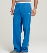 Elastic waist track pants with pieced side detail and zip pockets.