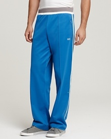 Elastic waist track pants with pieced side detail and zip pockets.