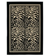 Bring the exotic landscape of the African Serengeti to you living space with this eye-catching zebra print rug. Four panels of black and white zebra stripes stand is stark contrast to each other, framed by a black border. The thick power-loomed pile presents a soft, luxurious finish and heaviness virtually indistinguishable from the work of master artisans. Made with meticulous detail of ultra-fine fiber that resists wear and permanent stains. One-year limited warranty.