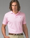 A year-round essential, the iconic polo in soft mercerized pima cotton has a gentle fit for the ultimate in comfort. Mercerized yearns for smooth hand and subtle luster Two-button placket Ribbed polo collar and armbands Multi-color polo detail at chest Silk grosgrain taping at split hem Machine wash Imported