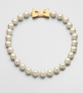 A classic styled piece in pearl-like beads with a sweet goldtone bow closure. Plastic beadsGoldtoneLength, about 18Tongue and box closureImported 