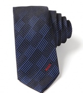 Skinny tie in luxurious silk, with tonal check pattern and embroidered HUGO logo lettering at the end.