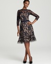 Tadashi Shoji's lace dress lends drama with a flared hem, detailed with sheer mesh stripes for a modern look.