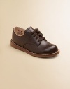 The timeless choice for boys and girls, expertly crafted in durable leather with excellent support and comfort. Adjustable laces Padded insole Rubber traction sole Leather ImportedPlease note: It is recommended that you order ½ size smaller than measured. If your child measures a size 7.0, you may want to order a 6½. 