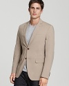 A classic two-button closure and a sleek fit define the timeless style of this luxe Salvatore Ferragamo blazer in a versatile tan hue.