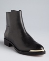 Rachel Roy takes Western-influenced details-pointed toes and metal toe accents-into ultra-sophisticated beetle booties.