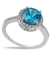 Blue perfection. B. Brilliant's pretty cocktail ring features a large, round-cut London blue cubic zirconia encircled by smaller, round-cut clear cubic zirconias (5-1/5 ct. t.w.) Set in sterling silver. Size 7.