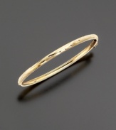 A perfect first bracelet, this small-sized bangle is made of delicately etched 14k gold in a flexible design.