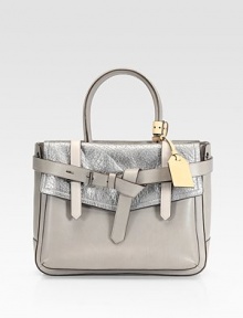 A tailored design combining, glazed glovetan, metallic tumbled grain, and glazed bridle leather wrapped with a buckled belt and contrast leather tag.Double top handles, 5½ drop One magnetic flap close outside pocket One magnetic snap close outside pocket Two inside zip pockets Two inside open pockets Cotton lining 12½W X 10H X 4D Imported