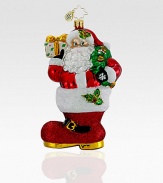 Hand-painted and glitter-dusted, an artfully crafted Santa of European glass rests inside an oversized boot. Hand-blownHand-painted5½ tallMade in Poland