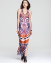 In a vibrant print, Nicole Miller's long, racerback dress lends a jetsetter look in semi-sheer silk, showcasing an elaborate, beaded neckline.