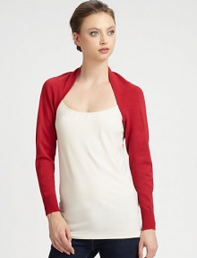 An open-front, long-sleeved knit design in a bold hue.Open frontLong cuffed sleevesAbout 10 from shoulder to hem80% rayon/20% nylonDry cleanImported